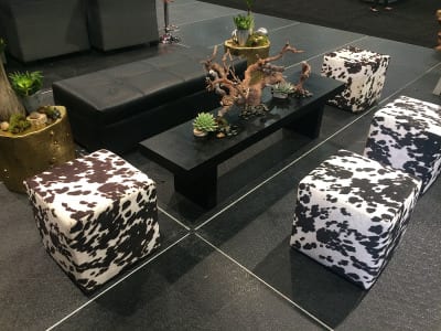 Cowhide-patterned ottomans serve as seating in this Wild West setting.