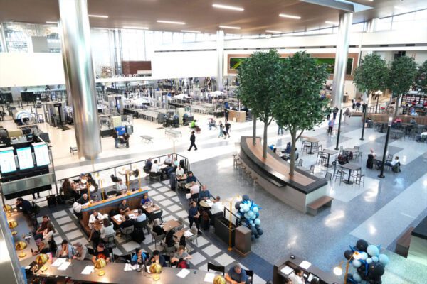 Interior view of Nashville International Airport with dining, seating, and security screening areas.