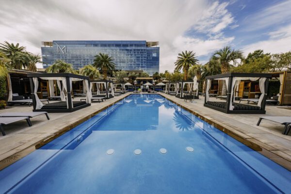 DayDream Pool Club at M Resort Spa Casino with pool, cabanas, and palm trees.