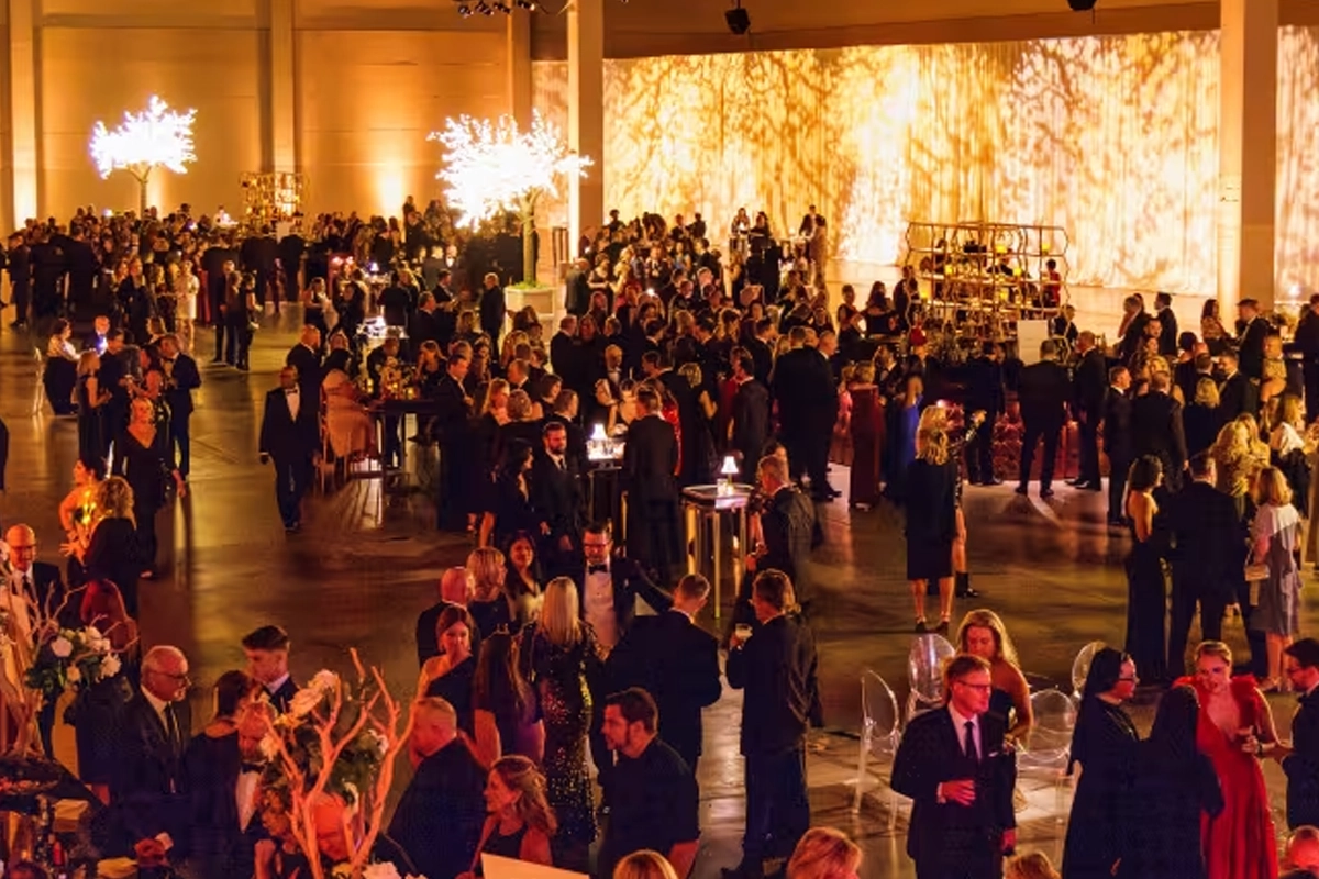 Guests attend a large reception inside an exhibit hall at the Peoria Civic Center