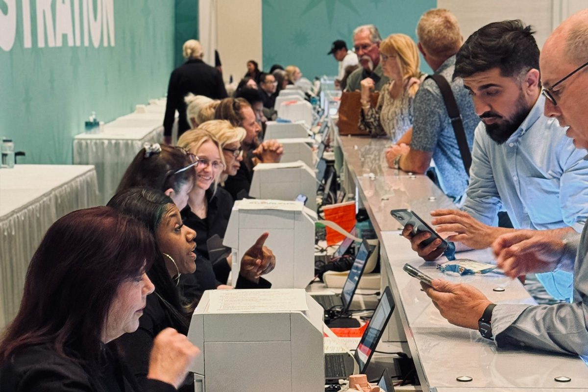 ESM Pros team members assist attendees at an event registration counter.