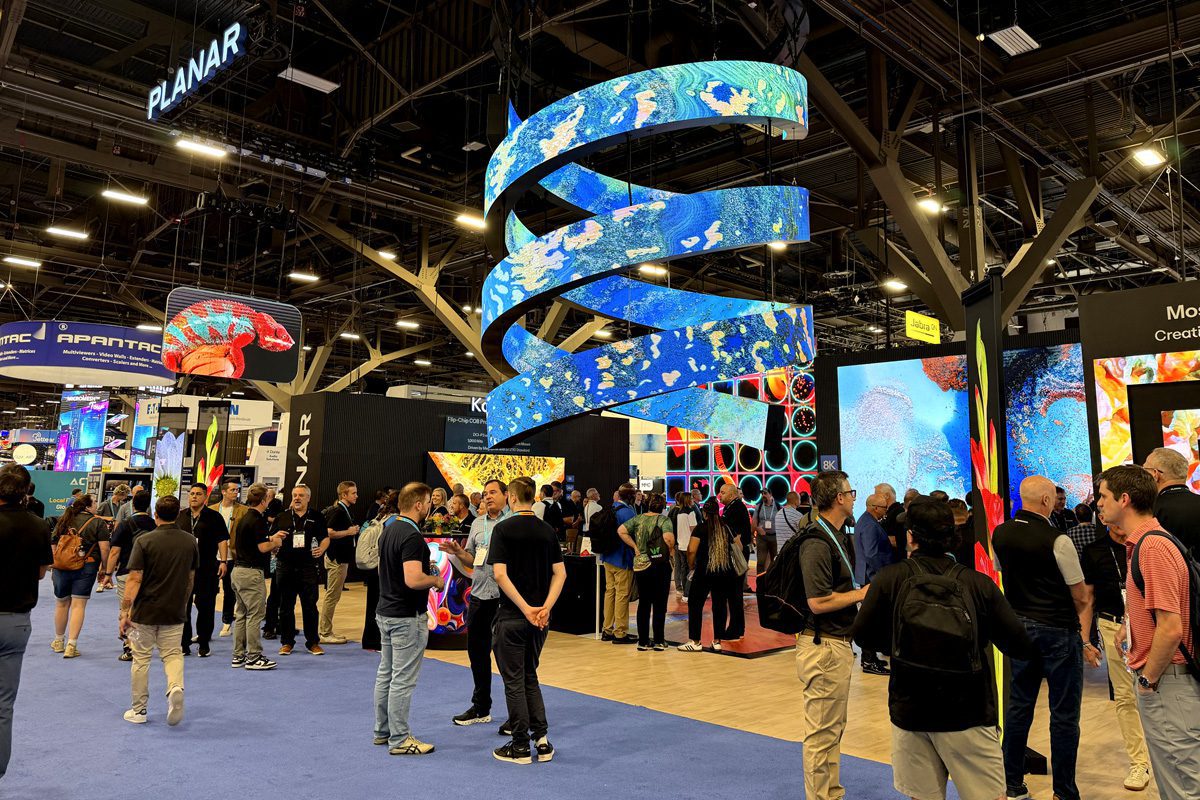 Attendees walk through LED display exhibits on the InfoComm 2026 show floor.