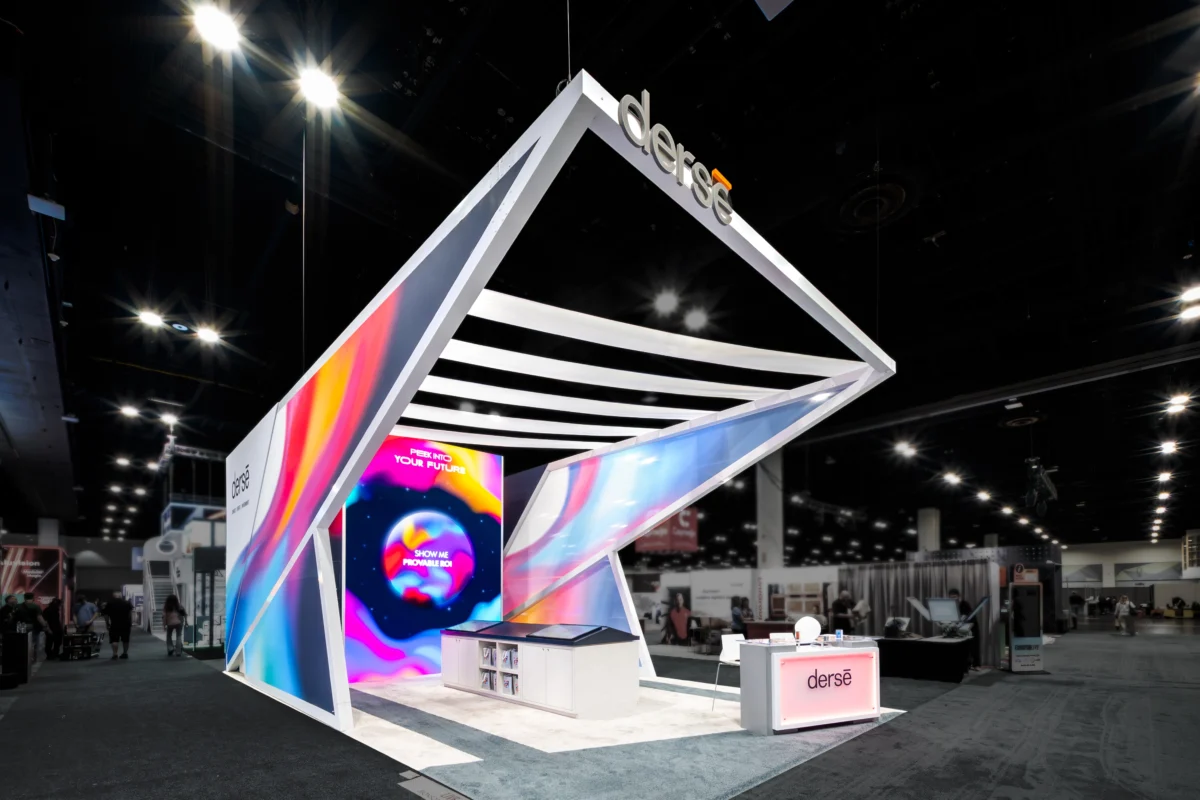 Derse self-promoting exhibit with angular architecture, illuminated graphics, and digital displays