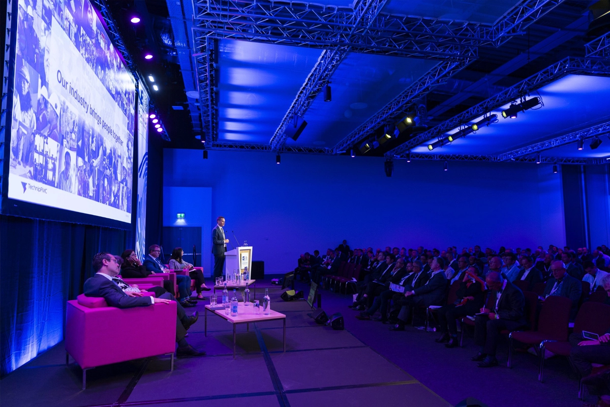 Speaker addresses attendees during a conference session at a Legends Global venue.