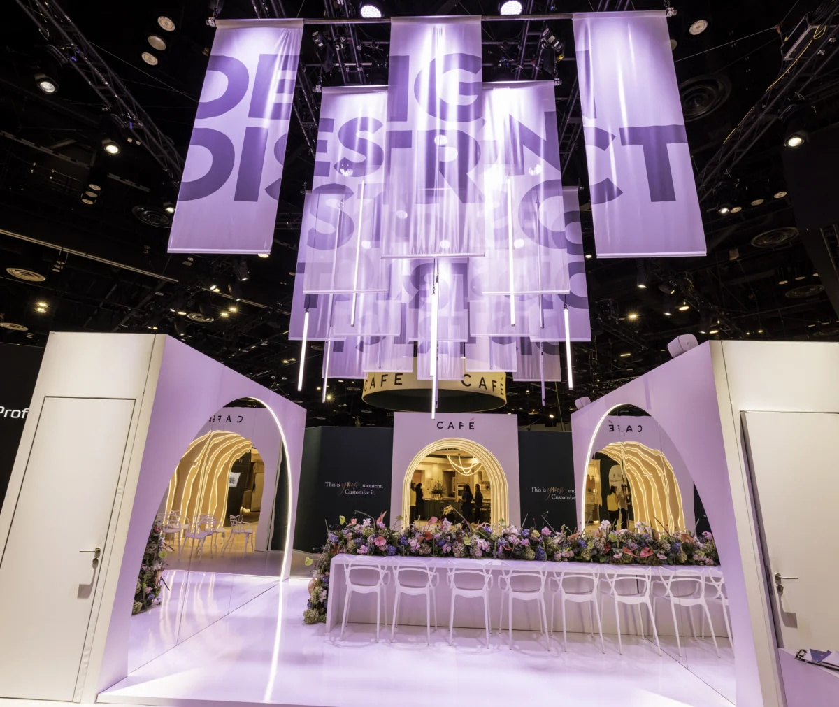 GE Appliances Design District rental exhibit with suspended fabric banners, illuminated arches, and café seating