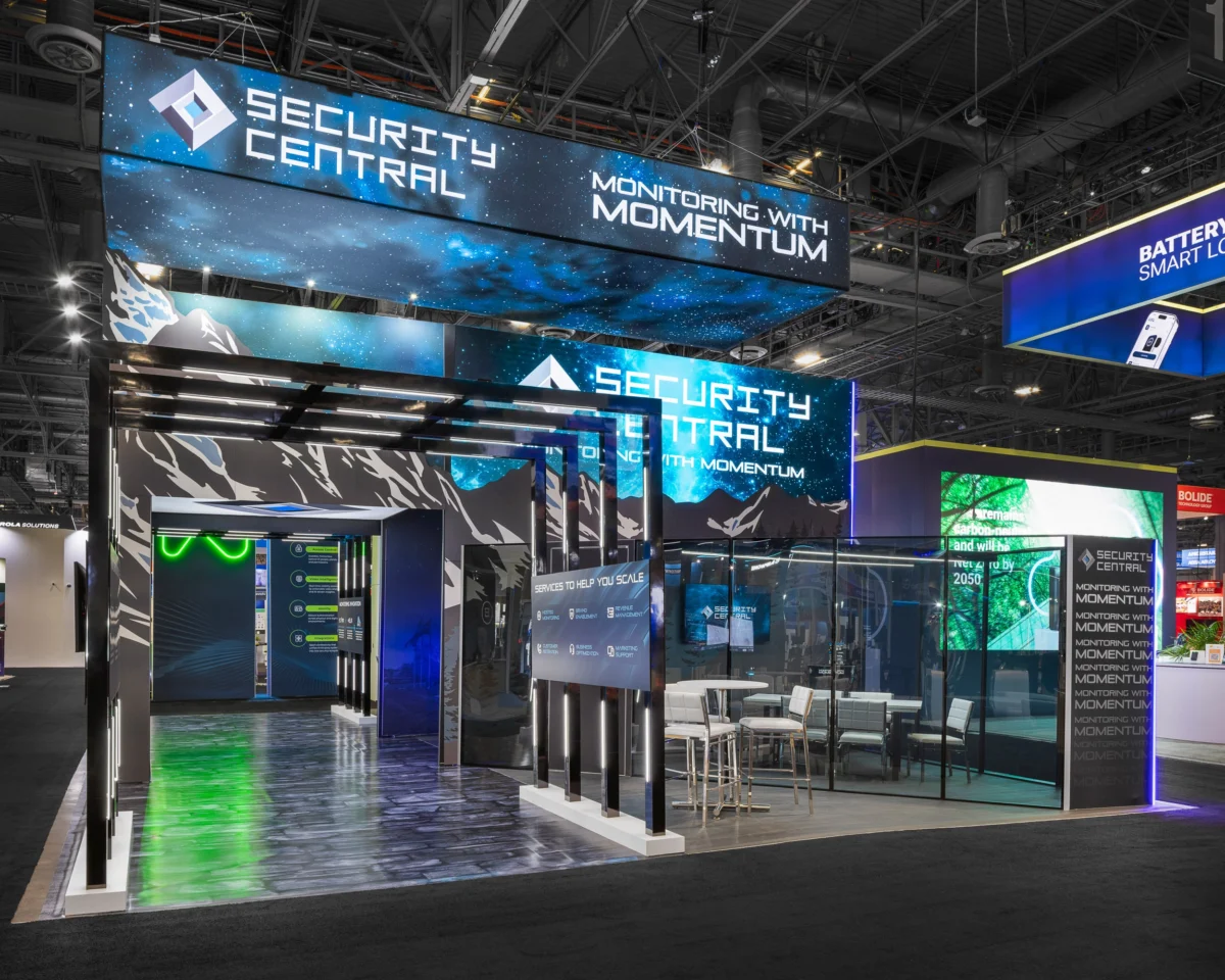 Security Central exhibit with large-format graphics, illuminated structures, and digital displays