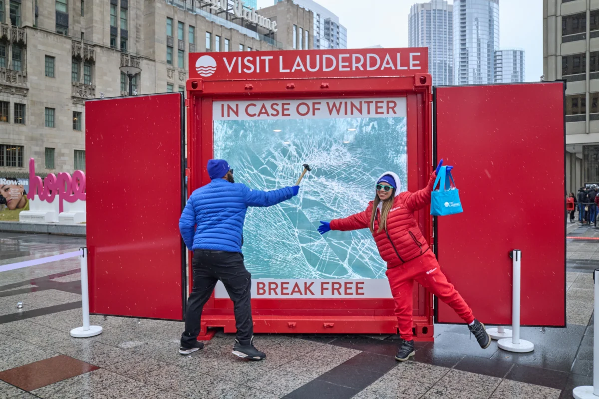 Visit Lauderdale winter activation with a red container display, cracked-ice graphic, and costumed brand ambassadors
