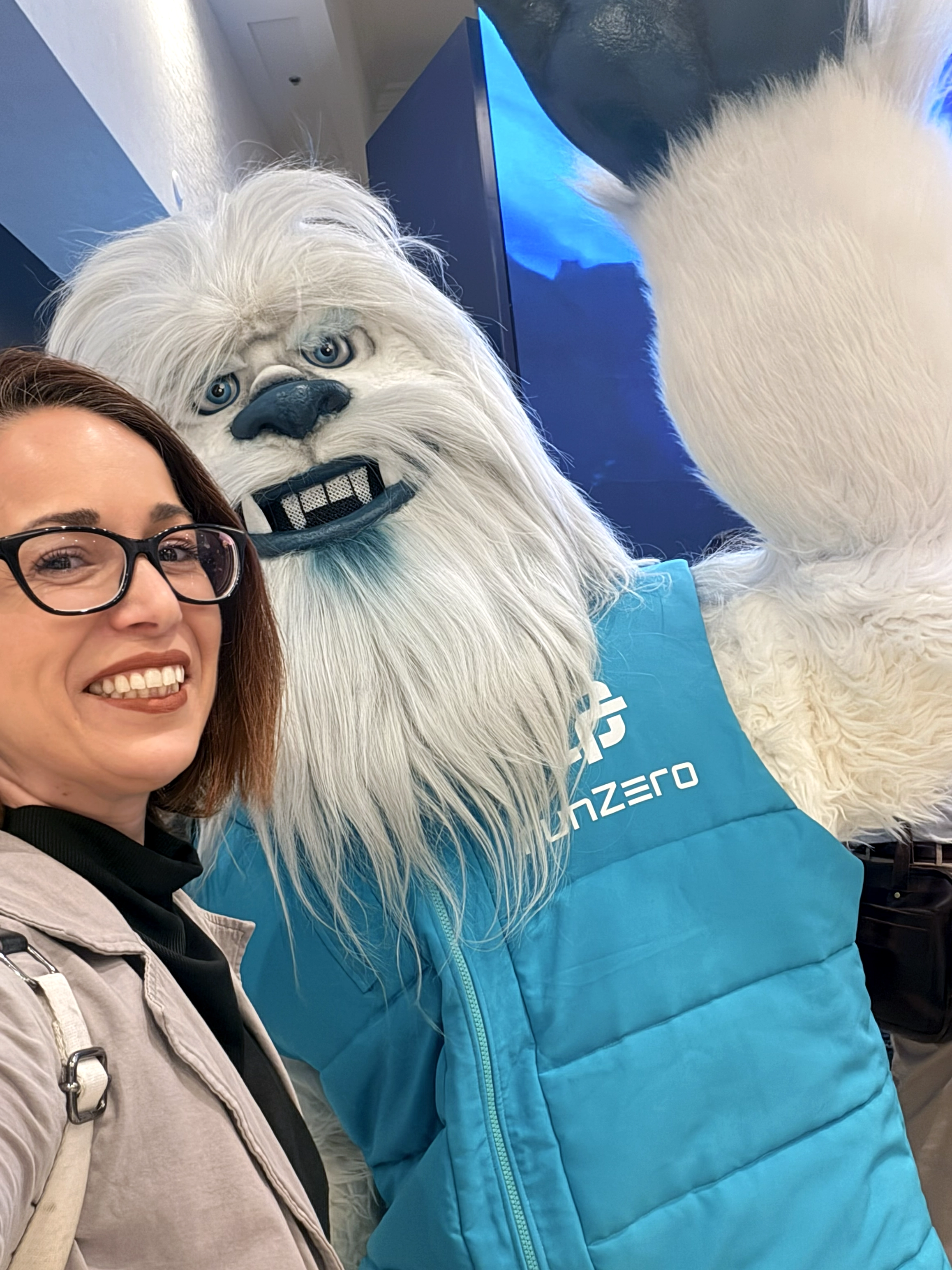 Melissa Skipsworth poses with a white yeti-style exhibitor mascot at Black Hat USA 2026