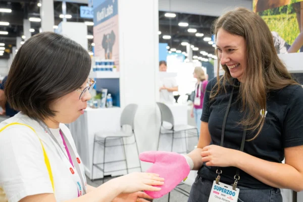 Olivia Abrams of TiCK MiTT demonstrates the company’s product at SUPERZOO