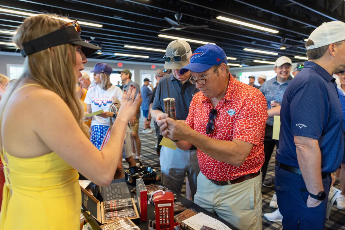 Attendees gather around a cigar table during the 2025 Randy Smith Memorial Golf Classic