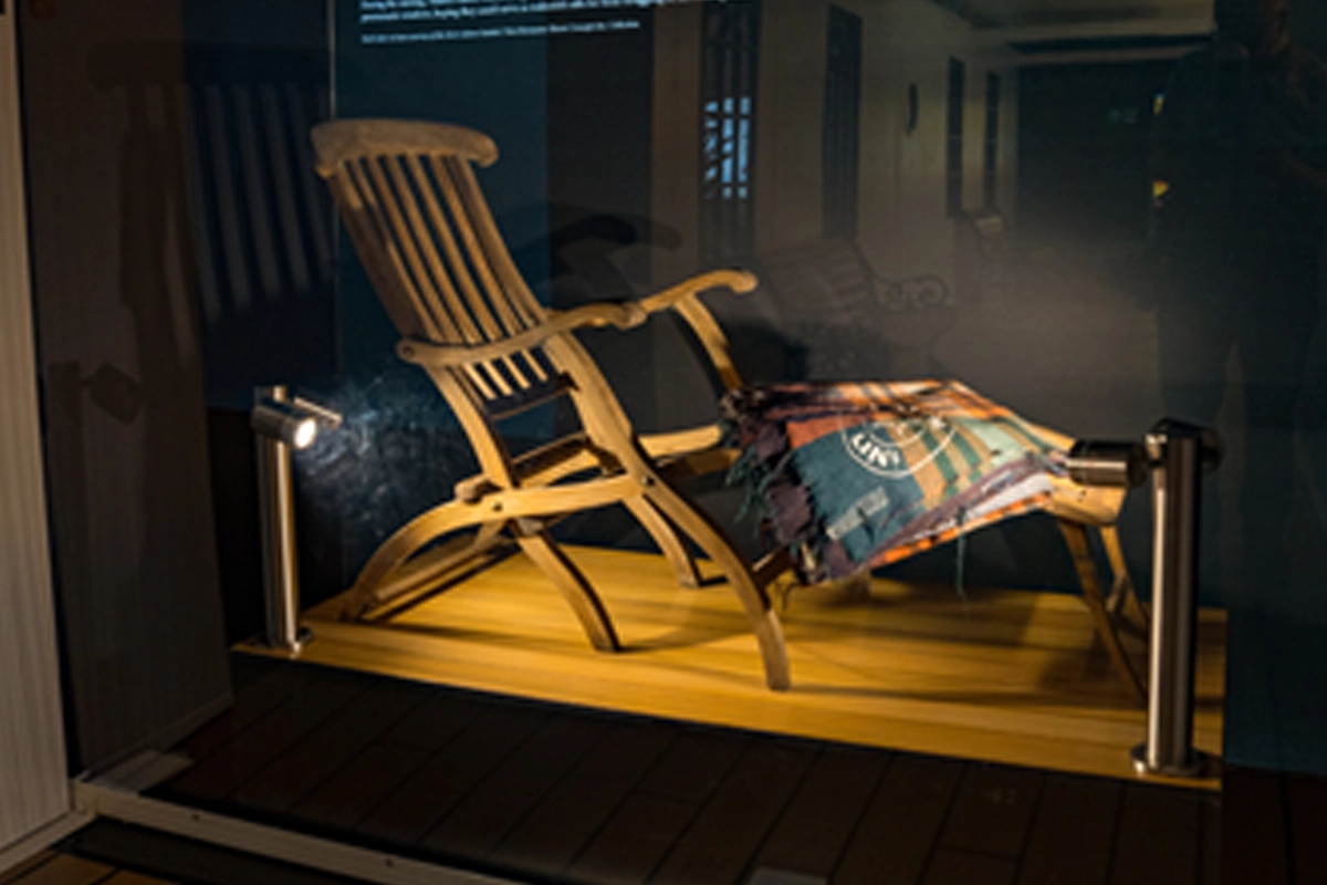 Original Titanic deckchair displayed in a museum-style exhibition case