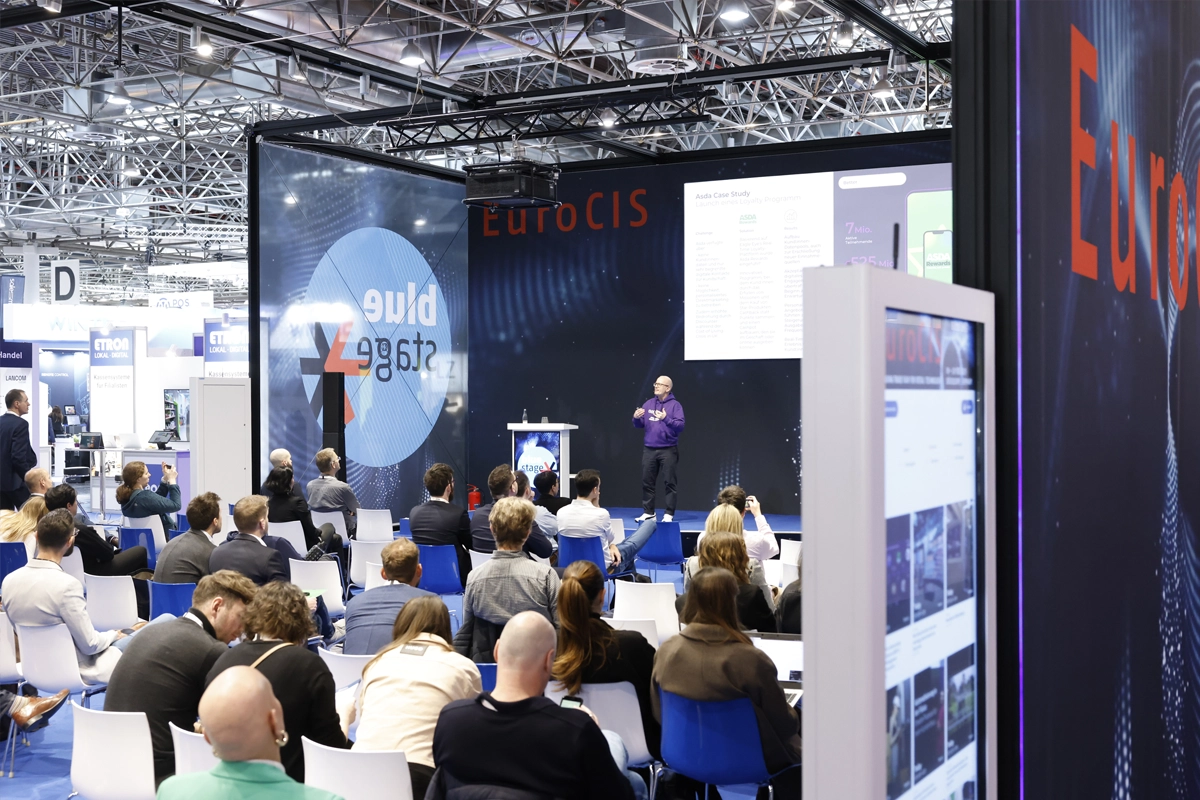 Attendees watch a presentation on the Blue Stage at EuroCIS 2025