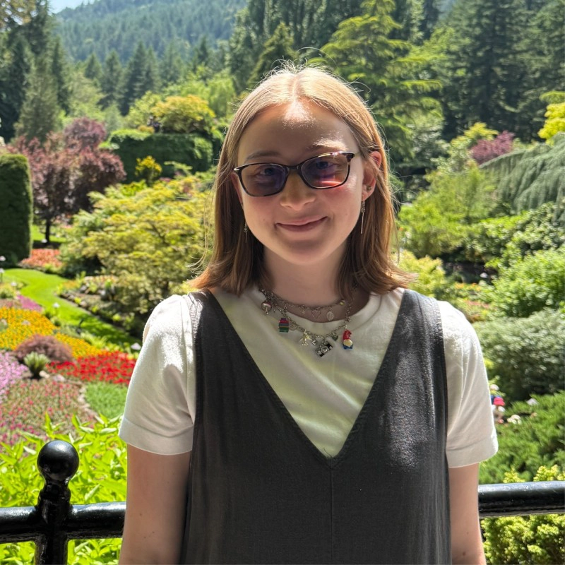 Alexi Duda wearing glasses in a garden