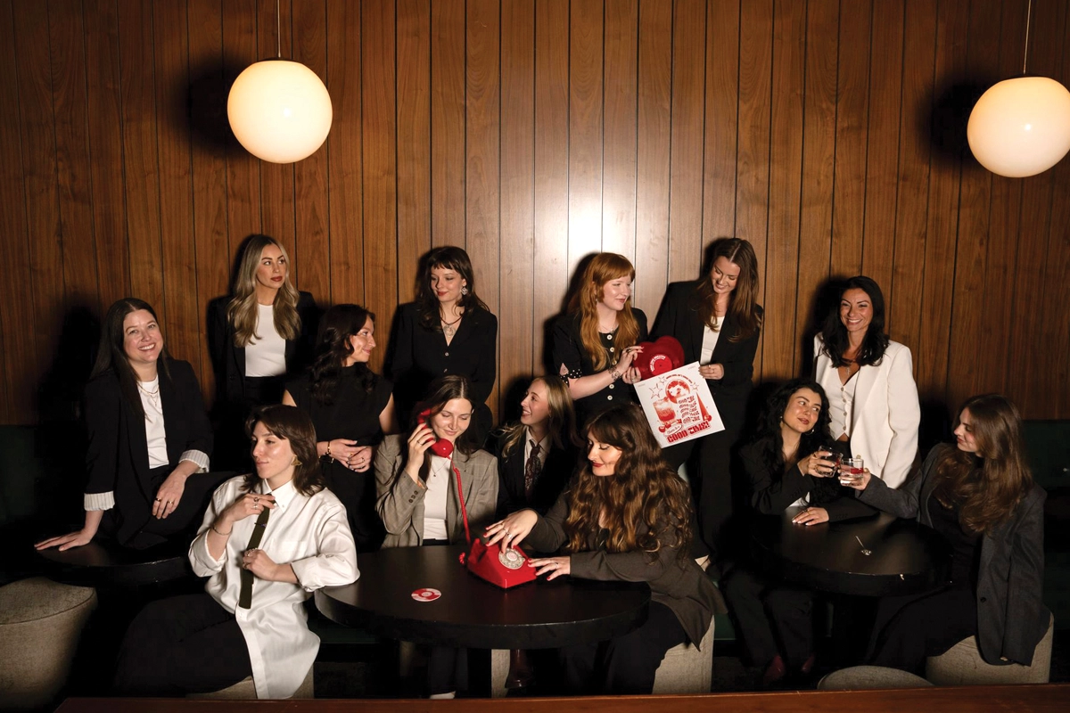 Good Time Creative team members gathered around tables in a wood-paneled room