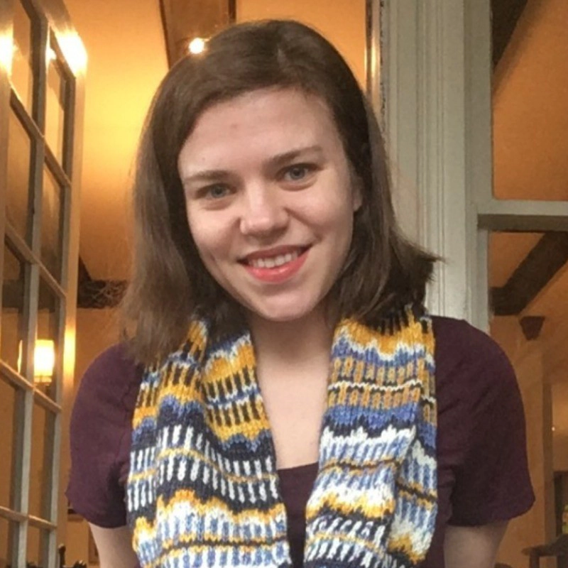 Jessica Doan smiling and wearing a patterned scarf