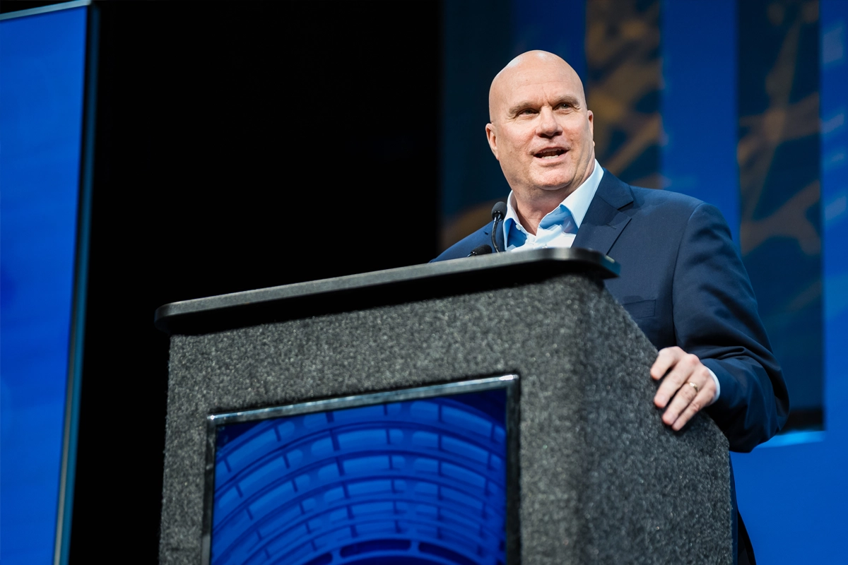 Brett C. Mitchell speaks at a podium during an IAVM event.