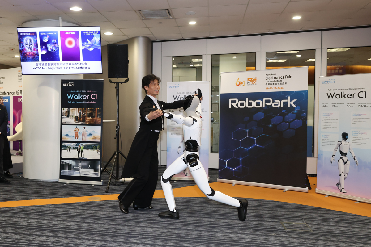UBTECH’s Walker C1 humanoid robot dances with a partner beside RoboPark signage at an HKTDC press conference.