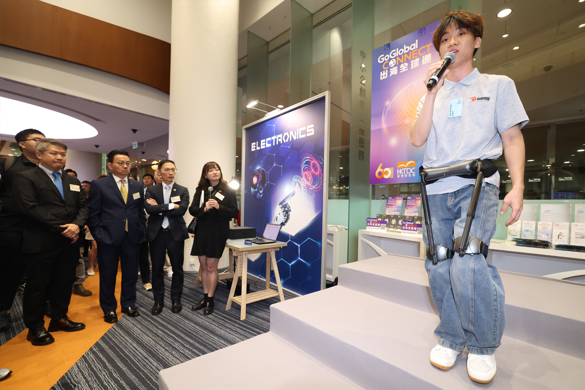 UBTECH’s Walker C1 humanoid robot dances with a partner beside RoboPark signage at an HKTDC press conference.