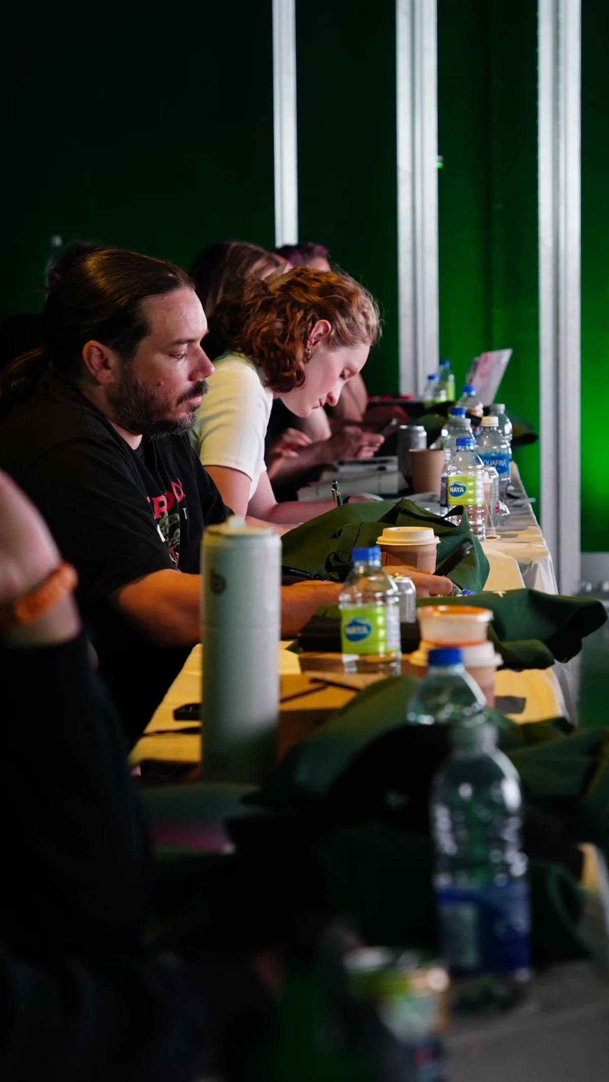 Attendees sit at a table and take notes during the Canadian beAcademy in Toronto.