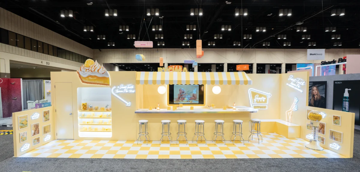 Yellow Sweetie Pie’s Diner exhibit with a counter, stools, and checkered floor