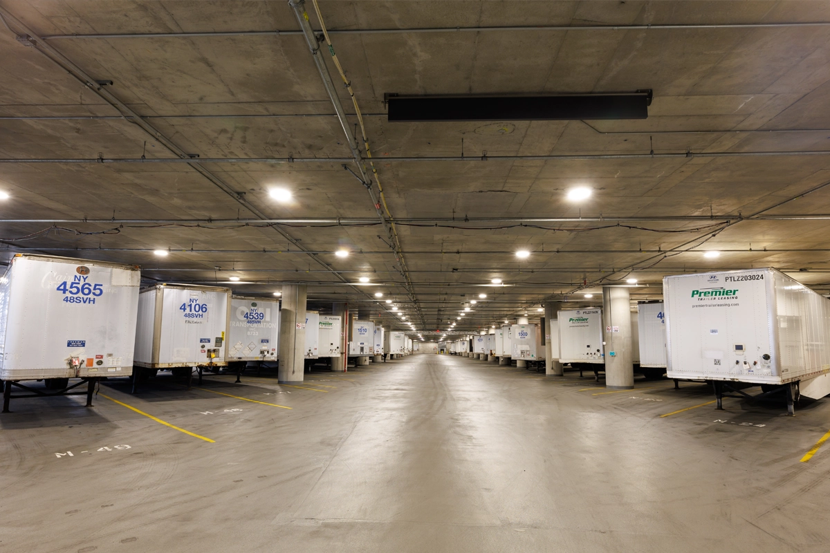 Truck trailers staged inside the Javits Center Truck Marshalling Building
