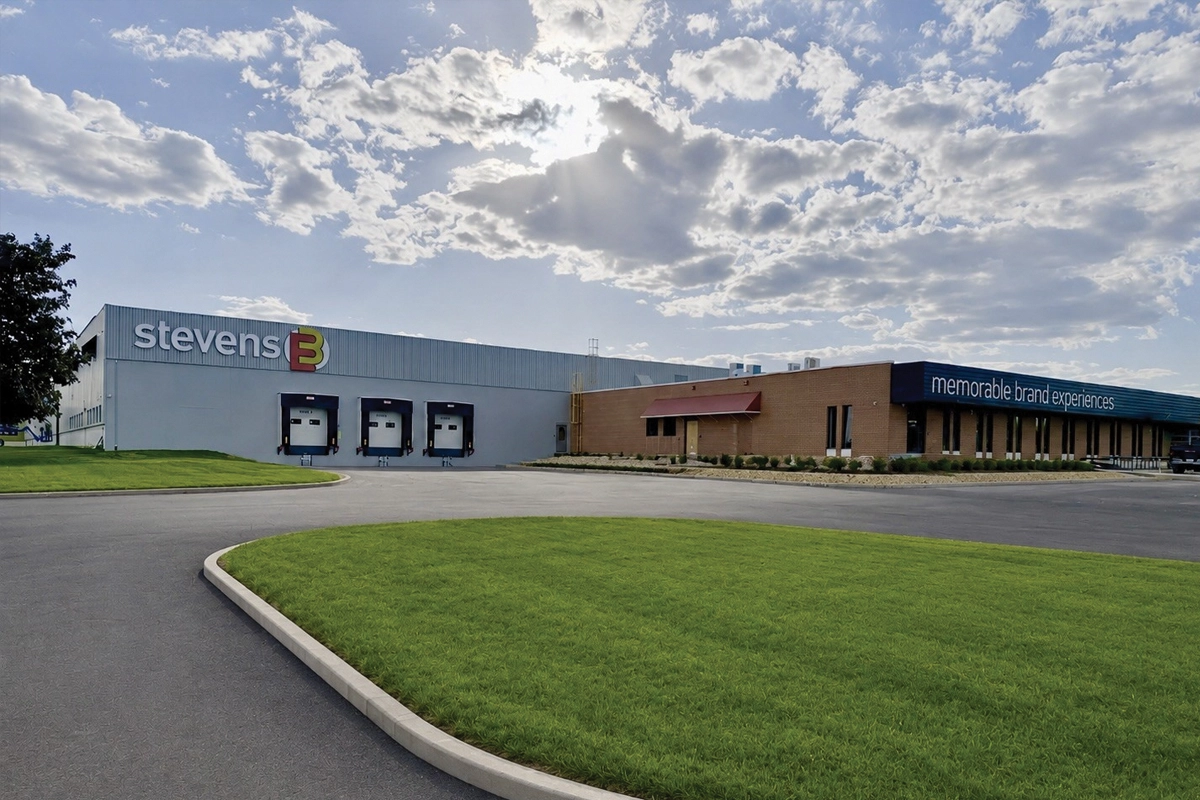 Exterior of the stevensE3 facility with three loading docks, offices and company signage