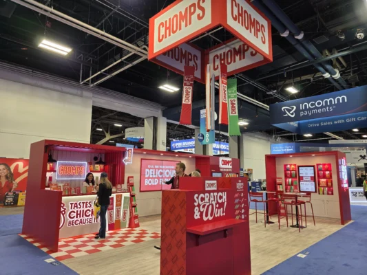 Chomps exhibit at NACS 2026 BOSS Awards features red and white displays, overhead signage, product sampling counters, and a promotional game area.