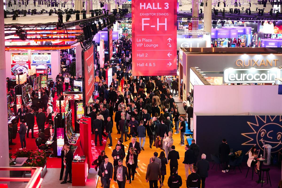 Attendees fill a busy ICE exhibition aisle surrounded by gaming displays and exhibitor booths beneath Hall 3 signage.
