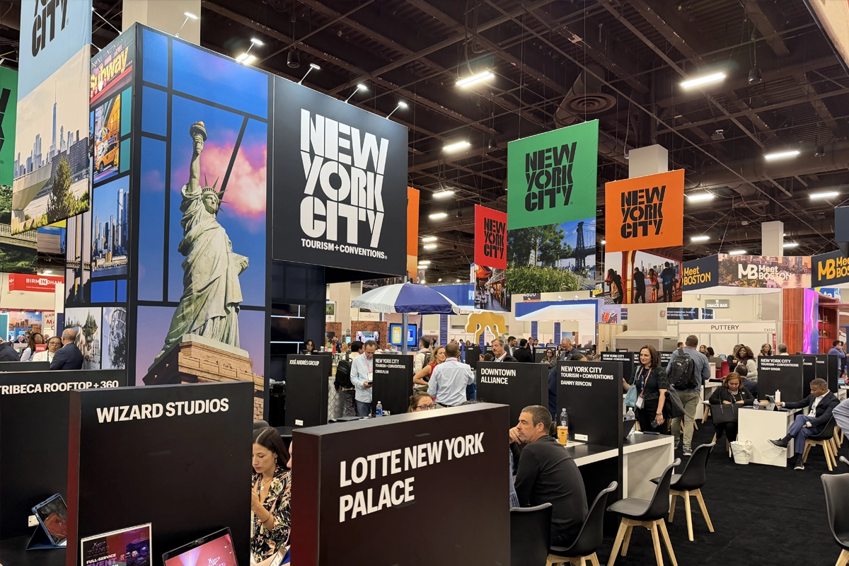 New York City’s exhibit features a large Statue of Liberty graphic, colorful hanging signs and individual meeting stations.
