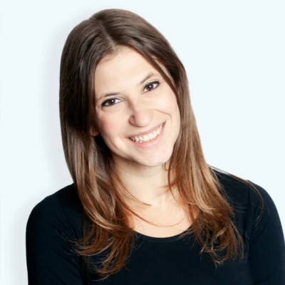 Allison Beck smiles in a portrait wearing a black top against a light background.