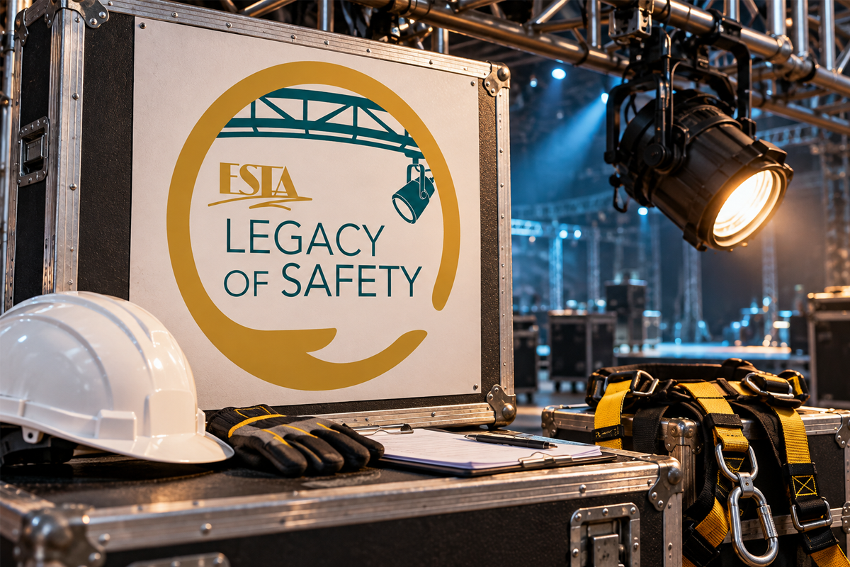 ESTA Legacy of Safety logo on an equipment case beside a hard hat, gloves and safety harness beneath stage lighting.